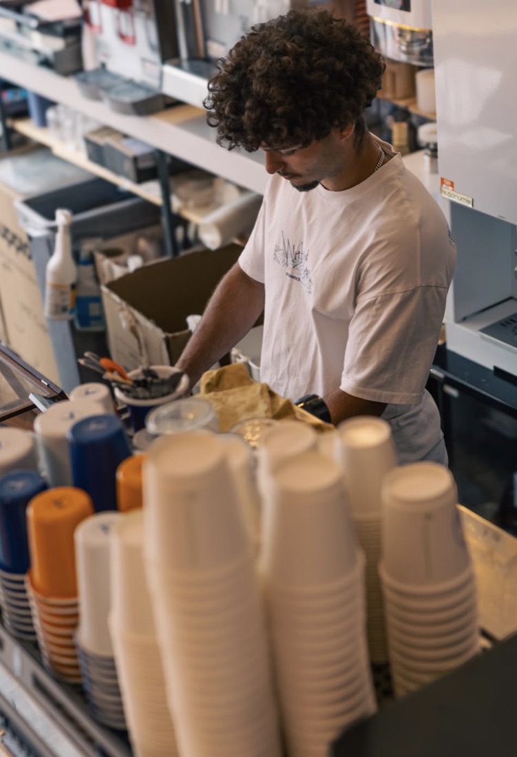 Barista working behind a sunlit counter
