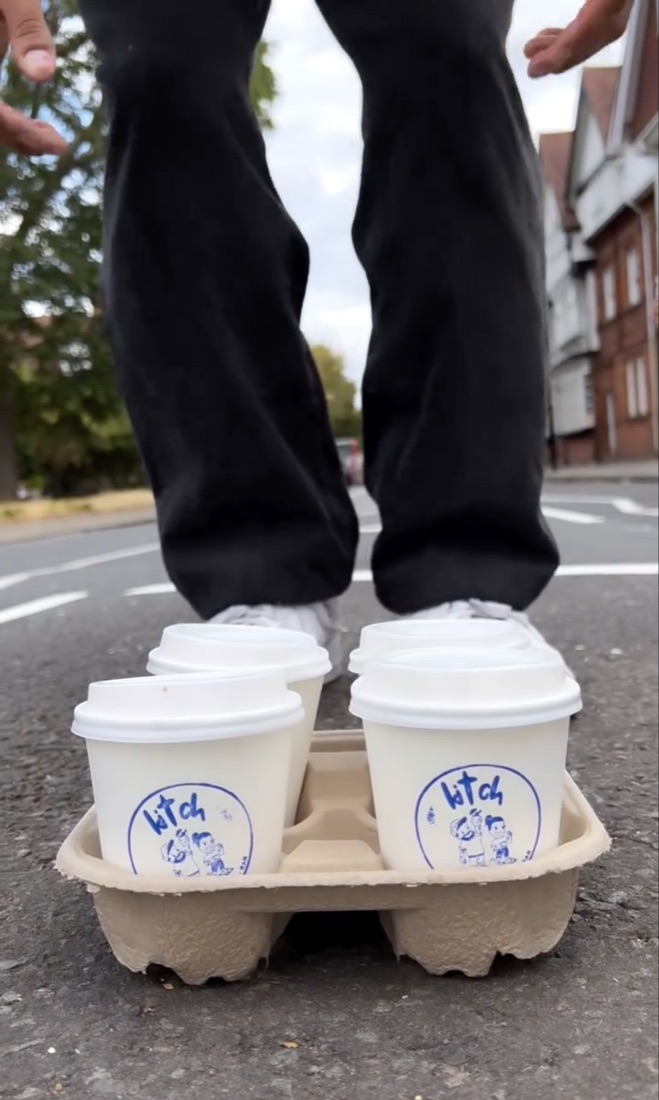 Two Kitch takeaway cups in a carrier on the road
