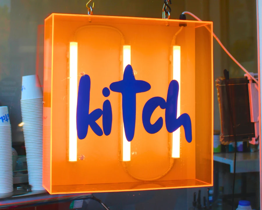 Kitch neon sign glowing orange in the café window
